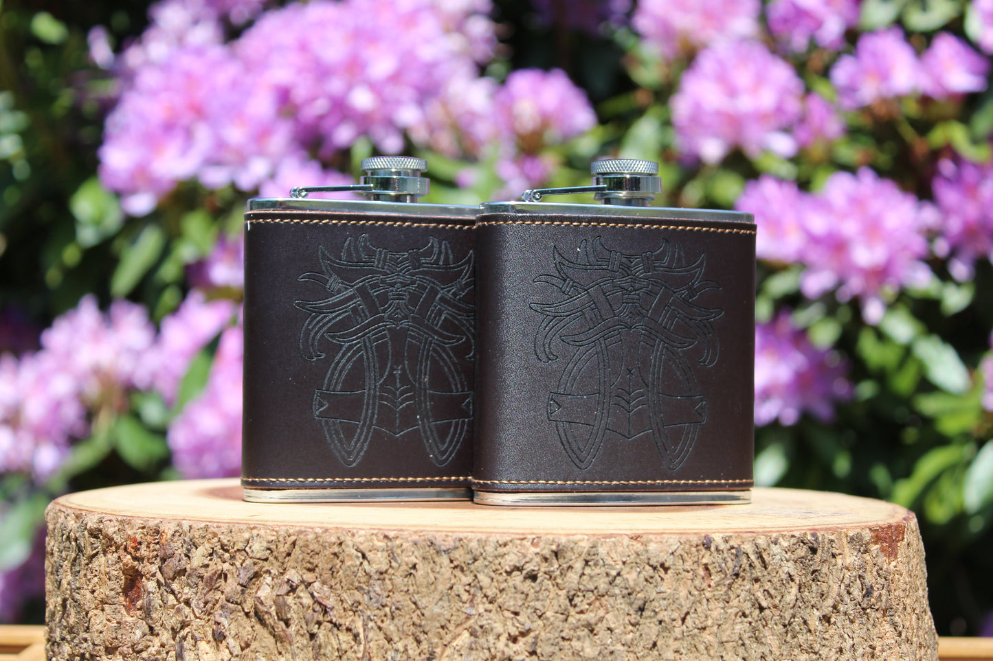 Leather hip flasks engraved with Thor and Tyr Godmask design, Norse mythology drinkware.