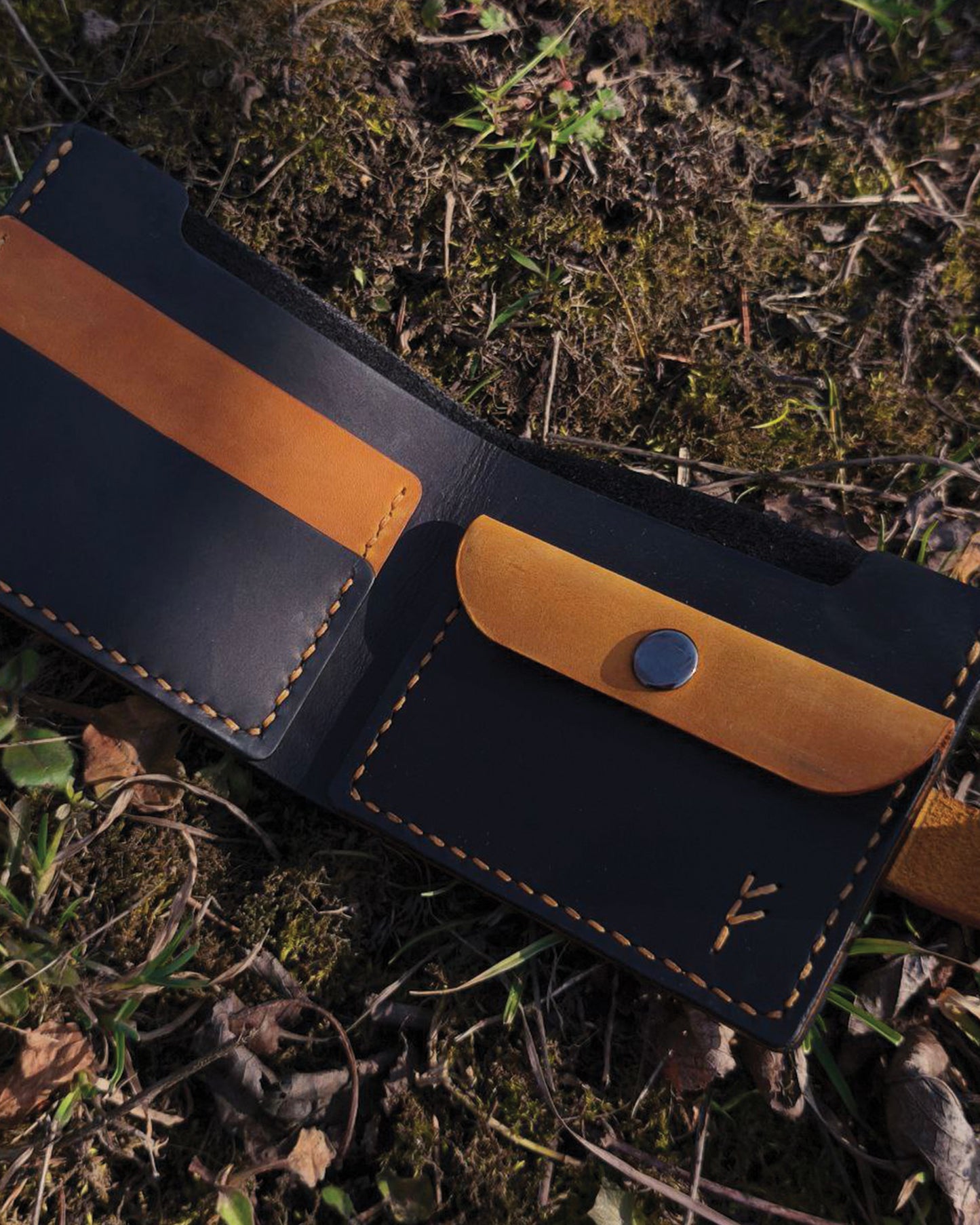 Handmade Viking leather wallets engraved with a custom Bindrune for wealth, prosperity & luck. Features stitched Fehu rune. Available in navy, black & green. Norse mythology meets everyday style.