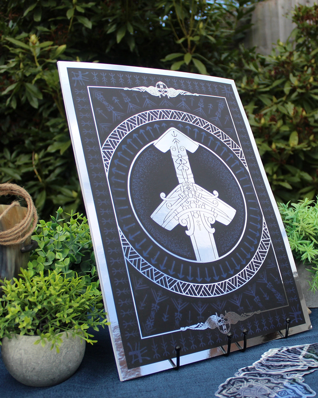 Silver foil A3 print of Norse god Tyr with Viking ornamentation and runic detail.