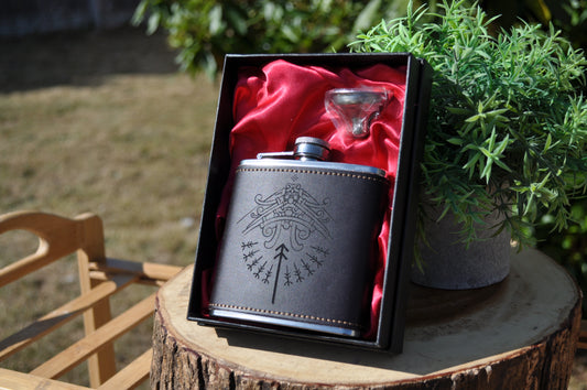 Leather hip flask engraved with Tyr Godmask design, Norse mythology drinkware.