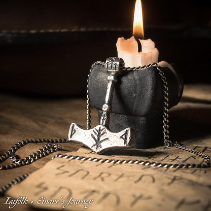 Handcrafted silver Thor's hammer Mjolnir pendant featuring a unique Viking protection Bindrune design for strength and safety.