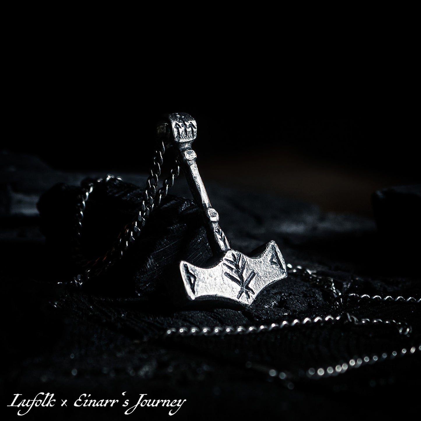 Handcrafted silver Thor's hammer Mjolnir pendant featuring a unique Viking protection Bindrune design for strength and safety.