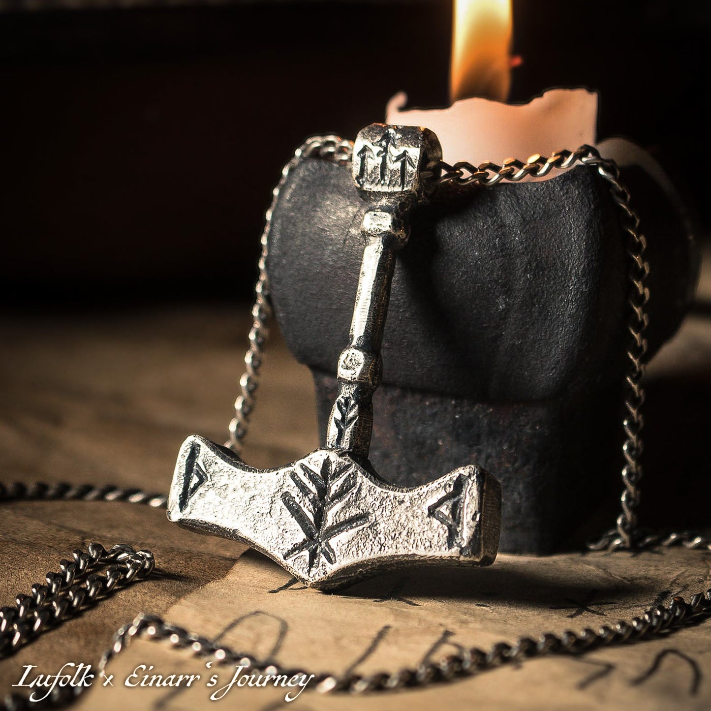 Handcrafted silver Thor's hammer Mjolnir pendant featuring a unique Viking protection Bindrune design for strength and safety.