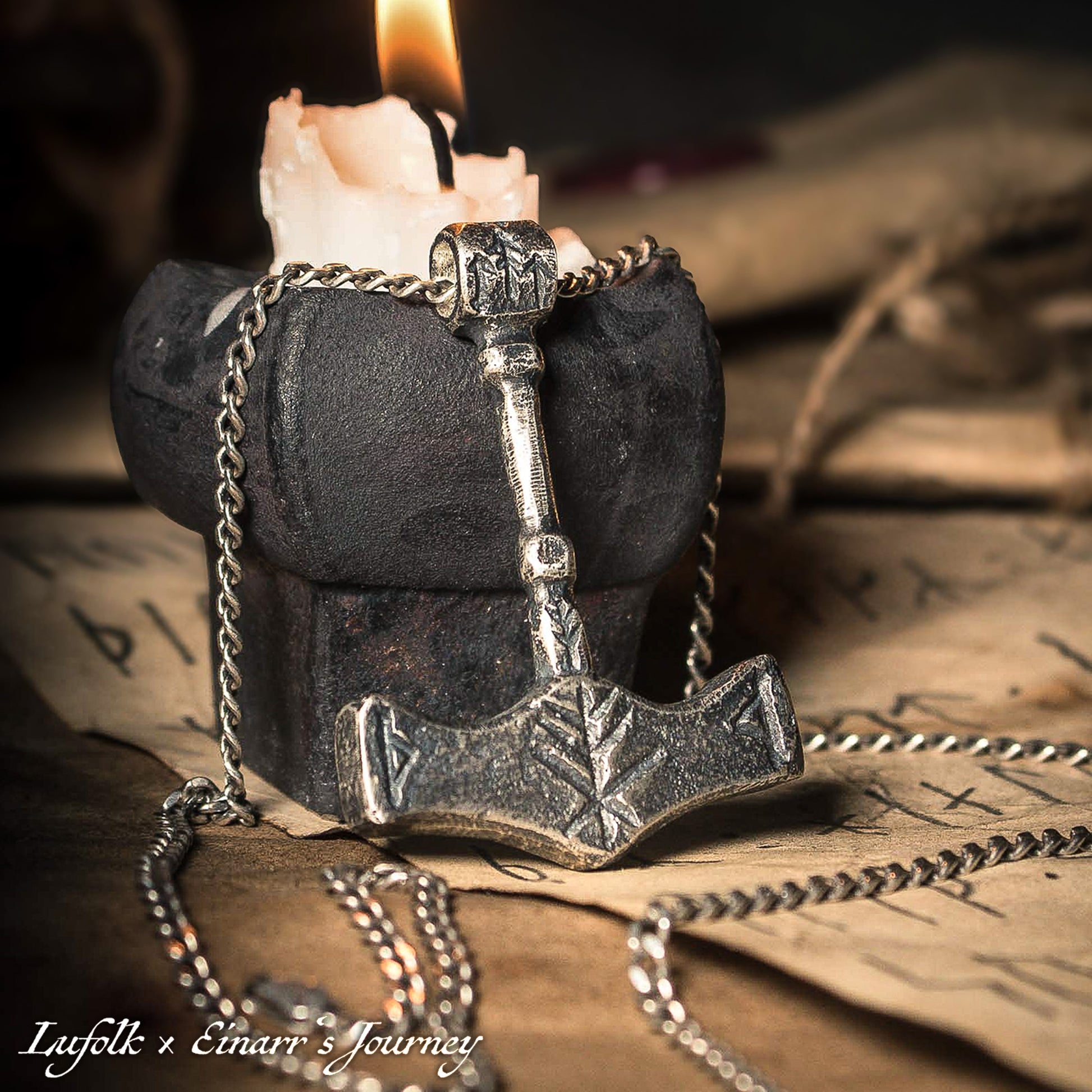 Handcrafted silver Thor's hammer Mjolnir pendant featuring a unique Viking protection Bindrune design for strength and safety.