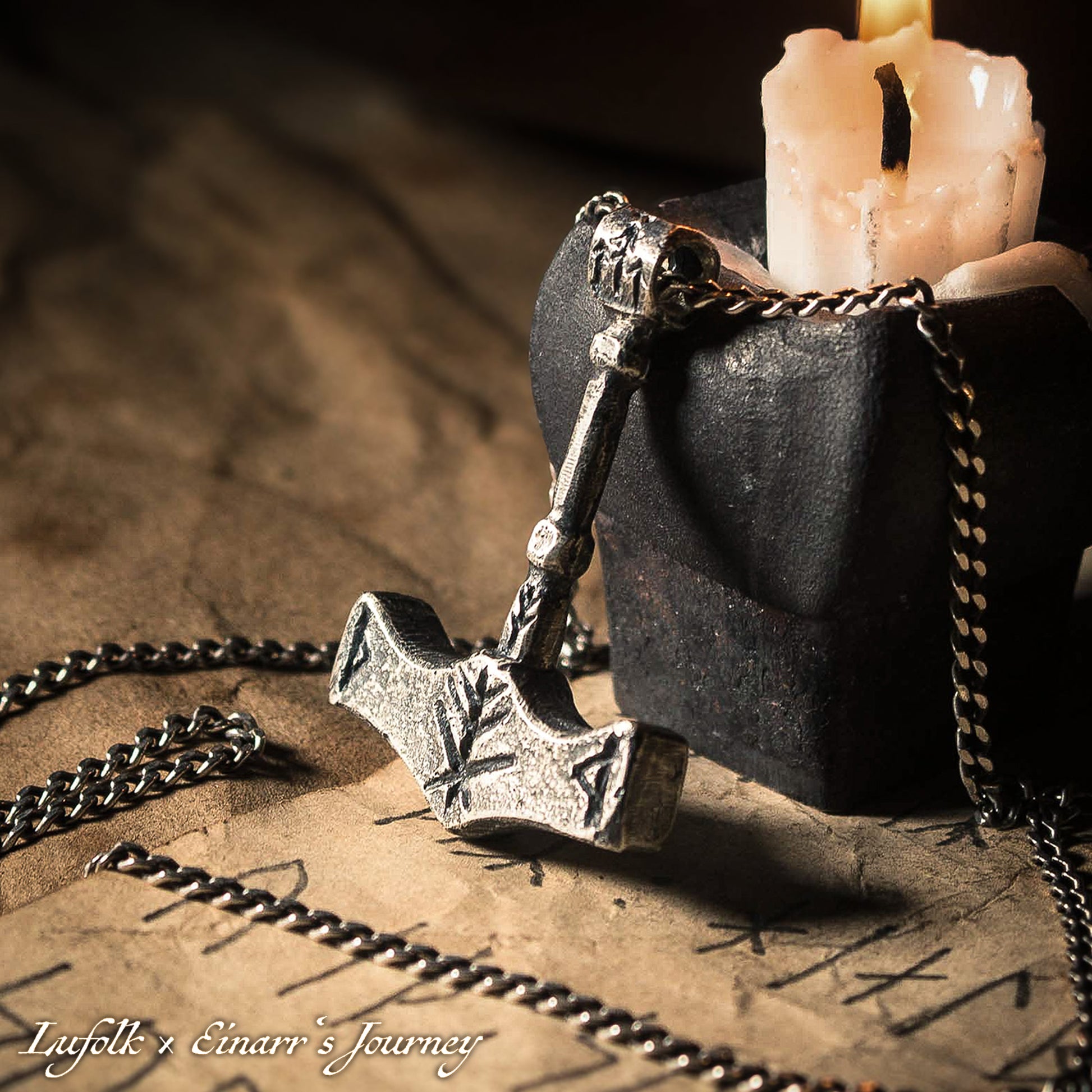 Handcrafted silver Thor's hammer Mjolnir pendant featuring a unique Viking protection Bindrune design for strength and safety.