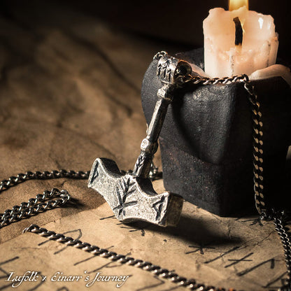 Handcrafted silver Thor's hammer Mjolnir pendant featuring a unique Viking protection Bindrune design for strength and safety.