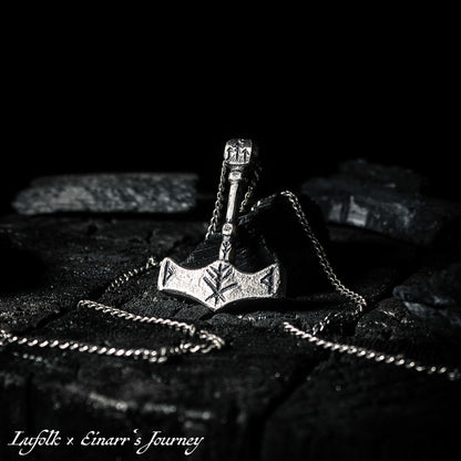 Handcrafted silver Thor's hammer Mjolnir pendant featuring a unique Viking protection Bindrune design for strength and safety.