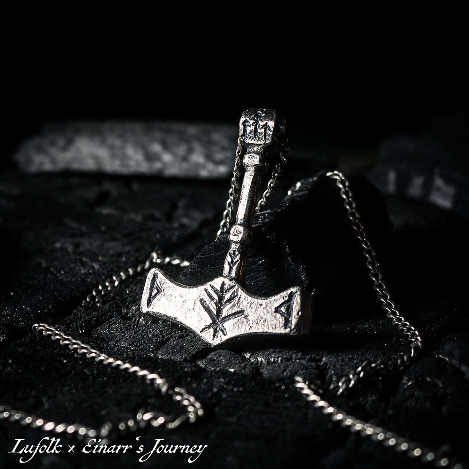 Handcrafted silver Thor's hammer Mjolnir pendant featuring a unique Viking protection Bindrune design for strength and safety.