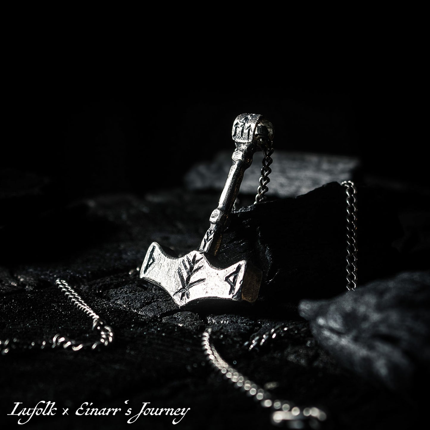 Handcrafted silver Thor's hammer Mjolnir pendant featuring a unique Viking protection Bindrune design for strength and safety.