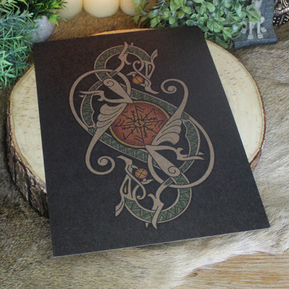 A4 print with a stunning depiction of the celestial wolves, Sköll and Hati, two great figures of Norse myth. This print captures their eternal pursuit in a striking, interwoven traditional Viking knotwork design. Created by Jonas Lau Markussen.