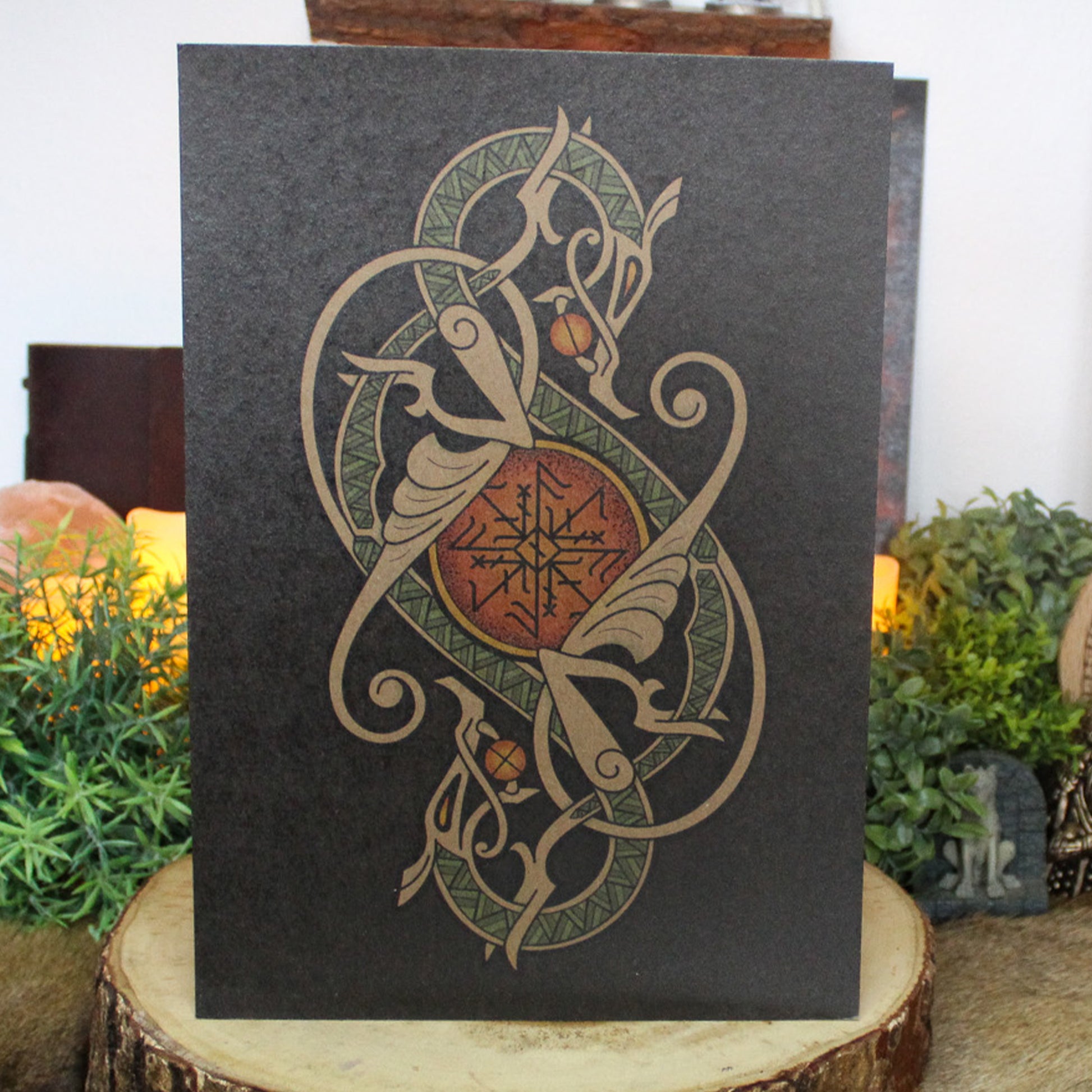 A4 print with a stunning depiction of the celestial wolves, Sköll and Hati, two great figures of Norse myth. This print captures their eternal pursuit in a striking, interwoven traditional Viking knotwork design. Created by Jonas Lau Markussen.